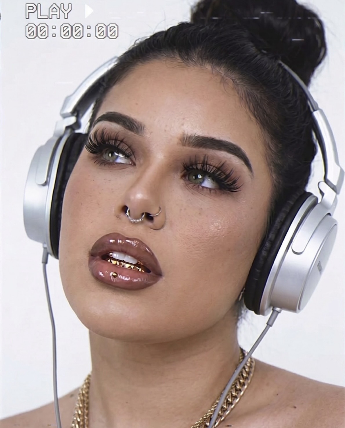 Bexi Bape wearing silver headphones