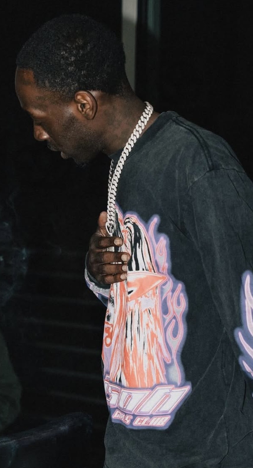 Hendrix Smoke wearing a graphic shirt and silver chain
