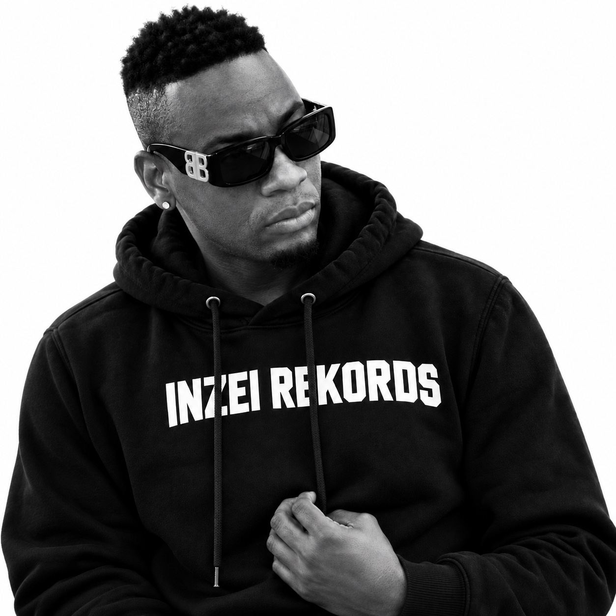 King Bentley in a black-and-white portrait wearing sunglasses and an Inzei Rekords hoodie