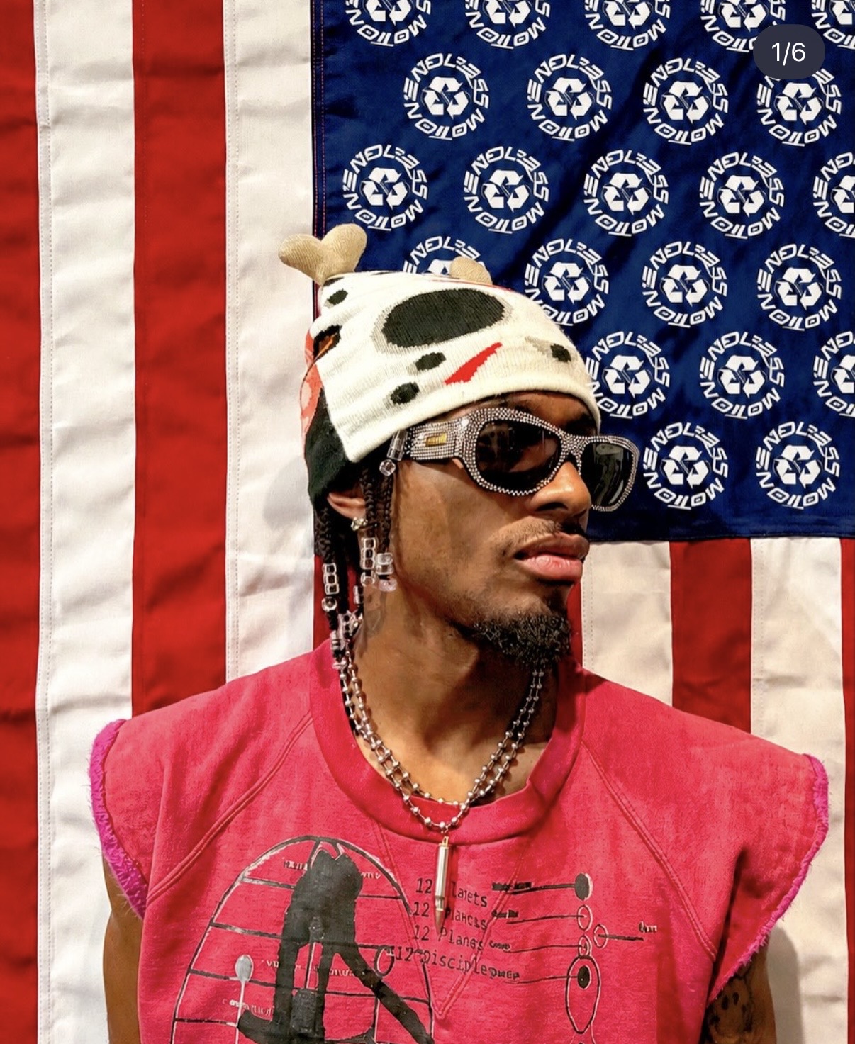 Le$LaFlame wearing sunglasses, a patterned hat, and a pink shirt