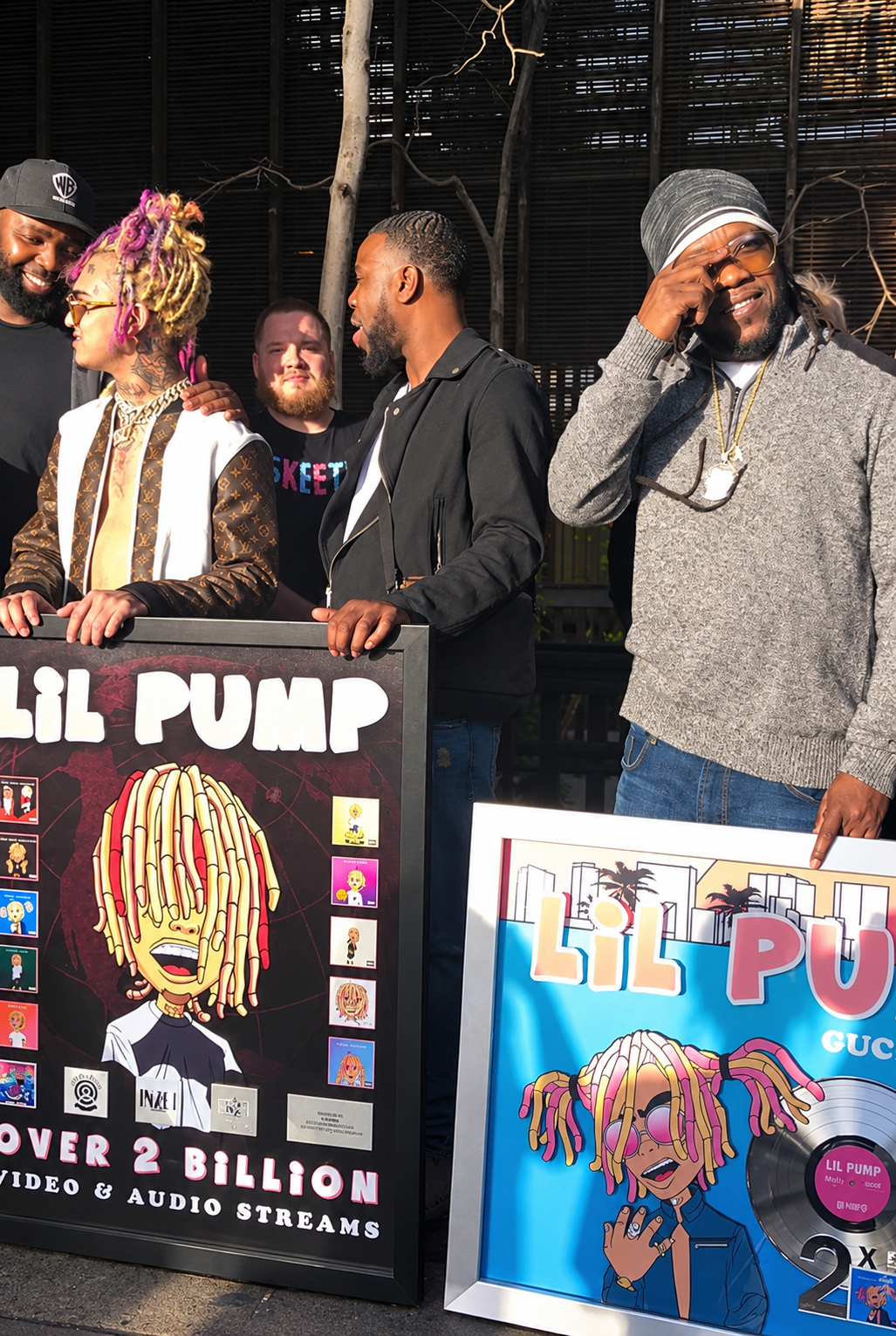 Lil Pump with the group holding award plaques, including a black plaque with an Inzei label