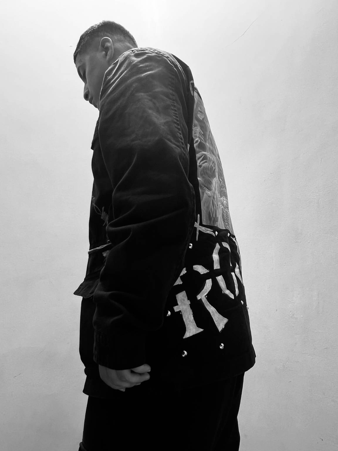 Rojas On The Beat in a black jacket, photographed in black and white