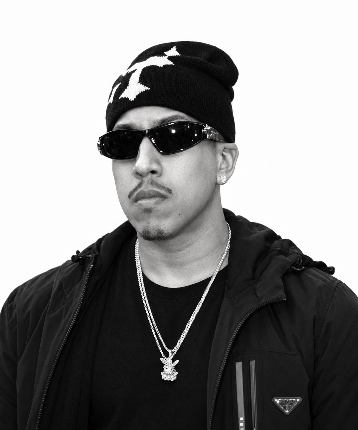 Santana Da Wolf in a black-and-white headshot wearing sunglasses and a beanie
