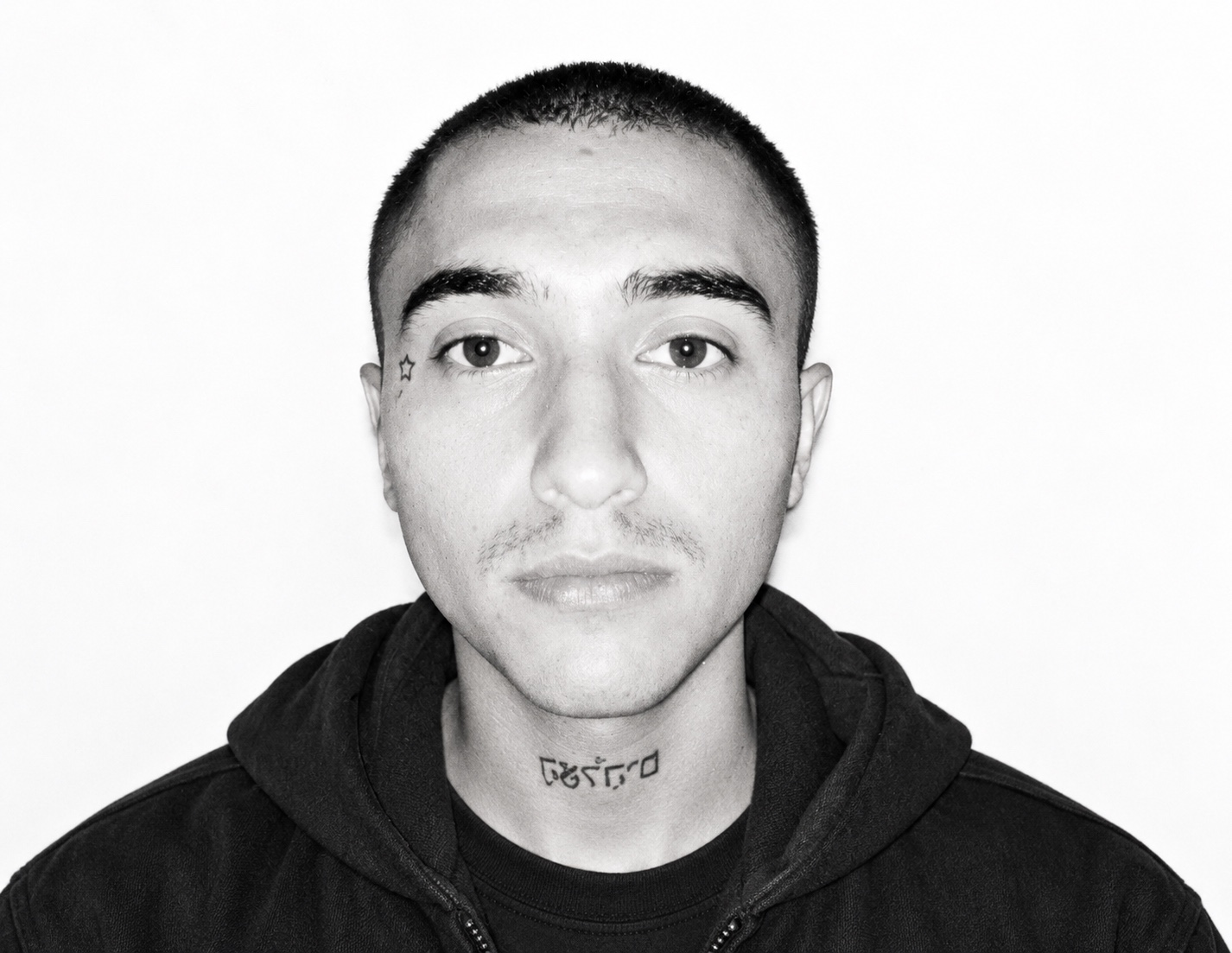 ZuluEnAlta in a black-and-white headshot against a white background